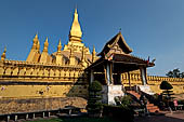 Vientiane, Laos - Surrounded by a cluster of pointed minor stupas the huge Pha That Luang shined under the warm light of the sunset.  